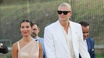 Erling Haaland becomes the 'Kingpin'! Man City striker & girlfriend Isabel Johansen dress to the nines for Dolce & Gabbana Alta Moda show in Rome